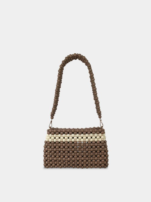 Brown and beige beaded handbag on a light gray background