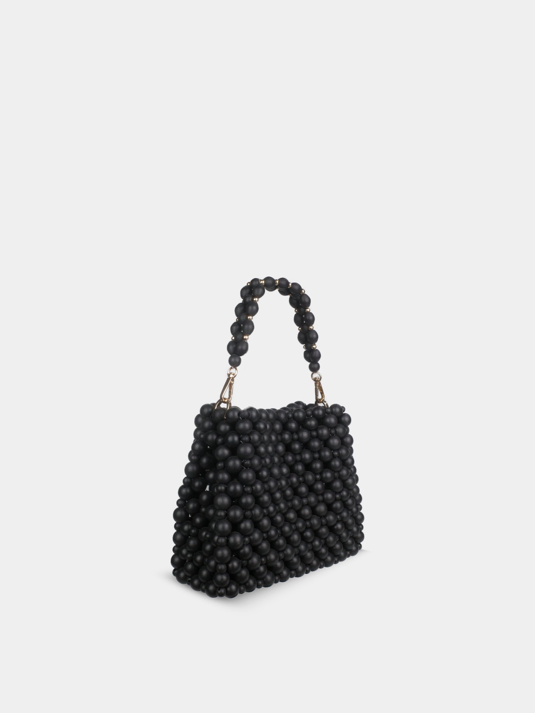 Black beaded handbag on a light gray background