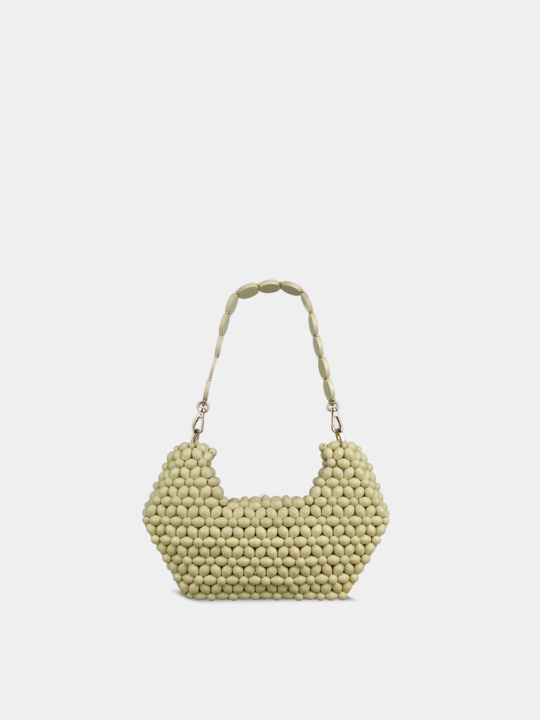 Green beaded handbag on a white background