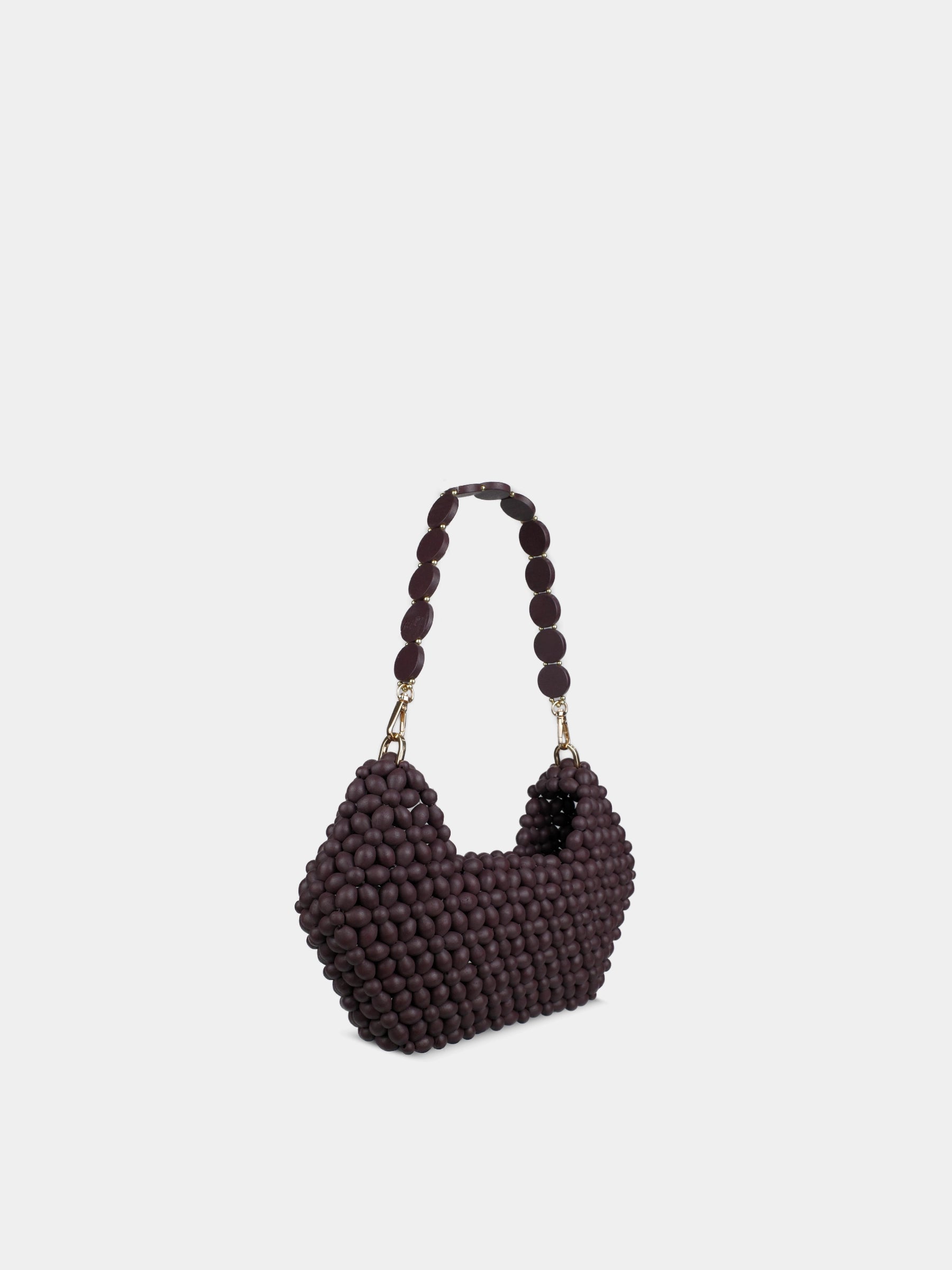 Heart-shaped beaded handbag on a light gray background