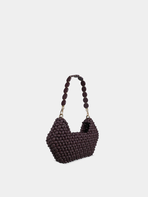 Heart-shaped beaded handbag on a light gray background