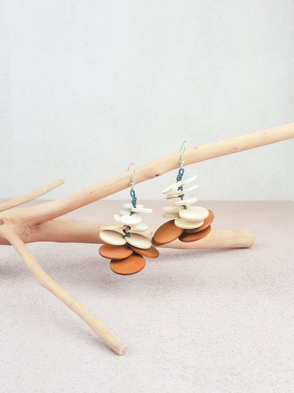 Handmade wood fish hook statement earrings in natural and brown.